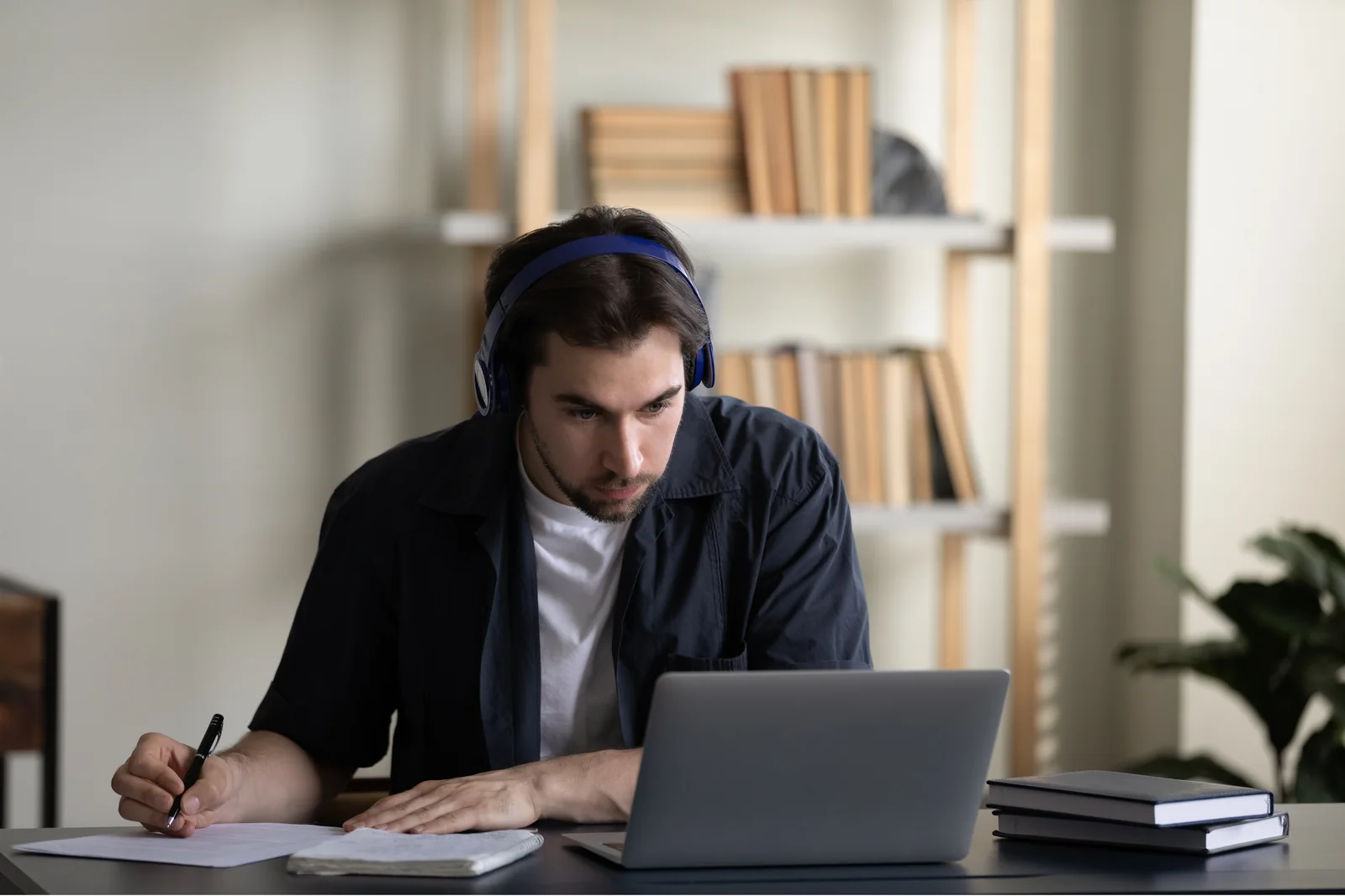 A student learning online with headphones and a laptop