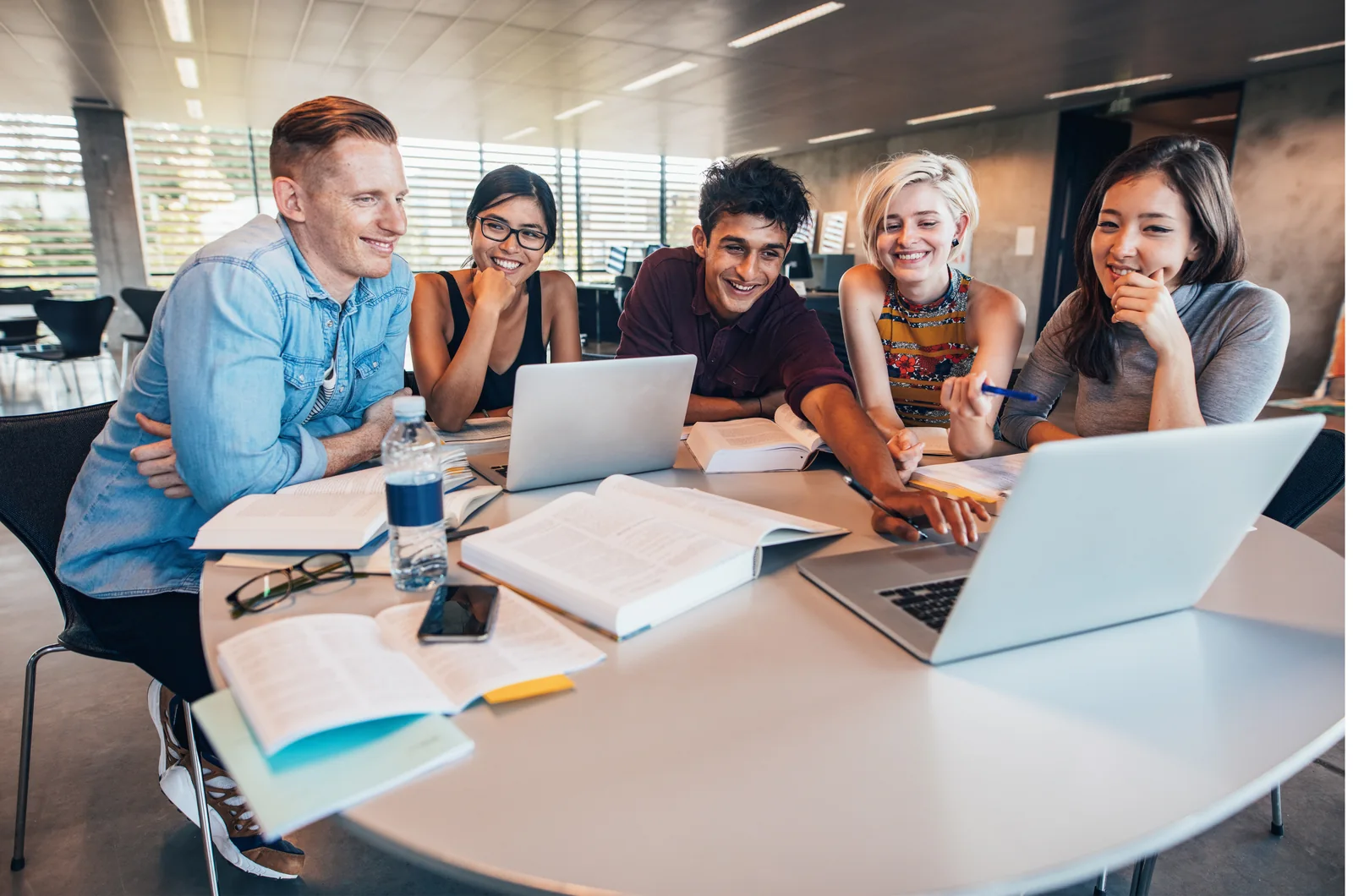 A study group discussing their work around a table